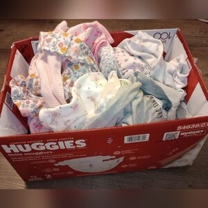 A box full of baby sleeping gowns